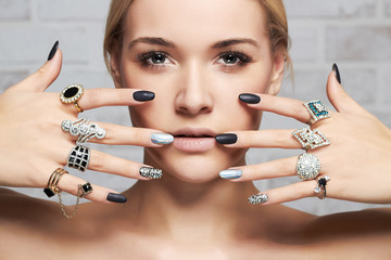 beauty face.woman's hands with jewelry rings.close-up beauty and fashion girl,manicure