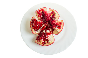 Pomegranate slices and garnet fruit seeds on table. Pomegranate whole. Useful fruit.