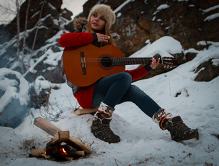 The girl with a guitar in the mountains