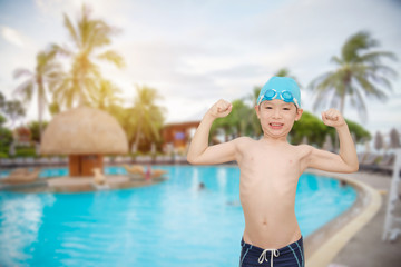 Young asian boy smiling at swiming pool