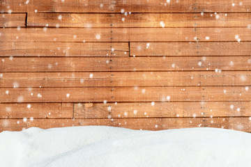 Christmas background with snow and blurred wood texture