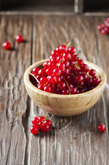 Macro photo of red currant on the wooden table