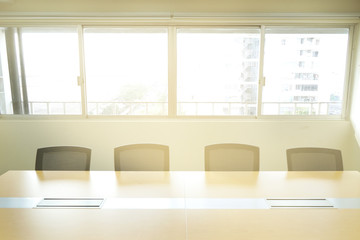 wooden table in meeting room white board sunlight from window