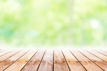 Empty wooden table with party in garden background blurred.