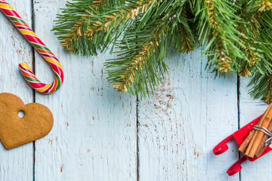 Christmas Tree Brunches, Cookie And Lollipop On White Wooden Boards.