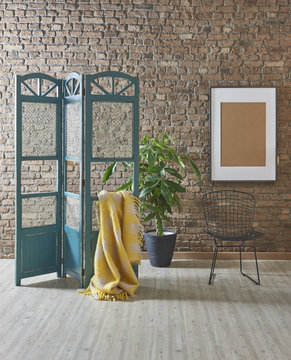 yellow wrap paravane frame and black chair with brick wall