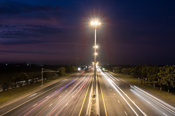 Speed Traffic at light trails on motorway highway at night,backg