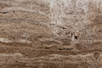 Dark brown travertine stone background.