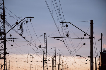 Railroad overhead lines against clear blue sky, Contact wire. High voltage railroad power lines on...
