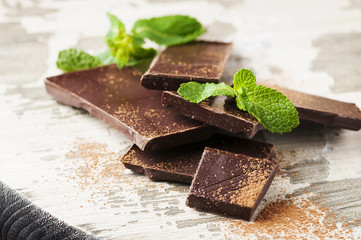 Brown chocolate and mint on the wooden table