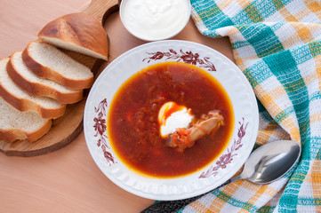 On the table soup with sour cream and bread  
