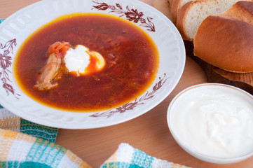 On the table is a soup with sour cream  