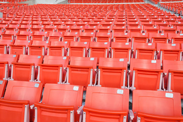 Obraz premium Empty orange seats at stadium,Rows of seat on a soccer stadium