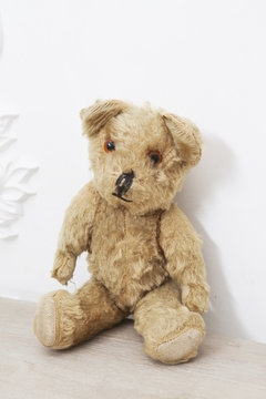 Retro Teddy Bear toy alone on wooden floor