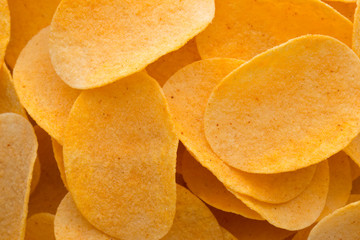 Close up potato chips on wood top view background.