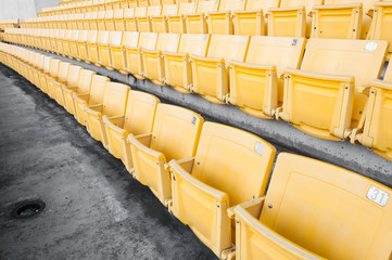 Naklejka premium Empty yellow seats at stadium,Rows of seat on a soccer stadium,select focus