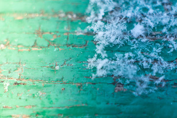 Fototapeta na wymiar macro snowflakes on green blackboard