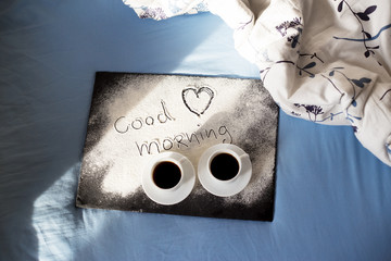 good morning inscription flour on a board with cups of coffee, heart Valentine's day