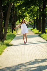 Young girl riding in the park on a skateboard