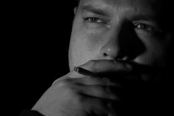 Young man smoking cigarette monochrome