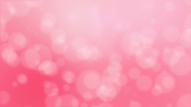 Romantic blurred bokeh background with floating circle particles against a gradient pink backdrop.