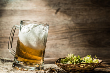 Frothy beer poured into mug