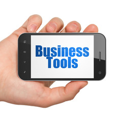 Business concept: Hand Holding Smartphone with Business Tools on display