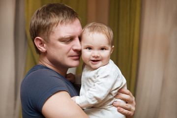 Young father kisses with his baby daughter

