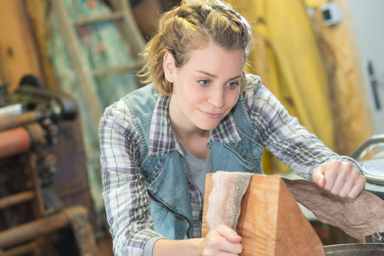 woman hold the sanding paper with wood block