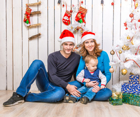 young family in red hats with little son