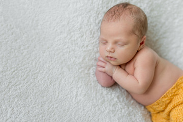 sweet sleeping newborn boy in yellow panties