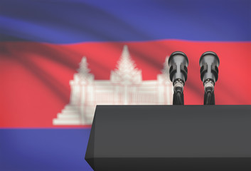 Pulpit and two microphones with a national flag on background - Cambodia