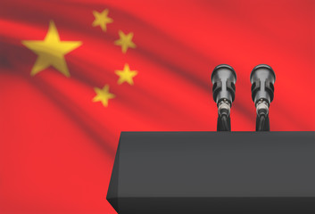 Pulpit and two microphones with a national flag on background - China