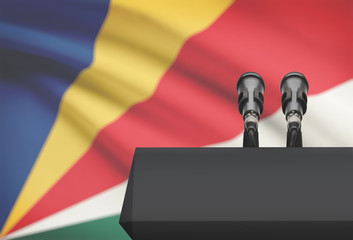 Pulpit and two microphones with a national flag on background - Seychelles