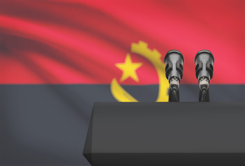 Pulpit and two microphones with a national flag on background - Angola