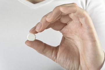 Pills in woman hand.