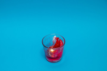 Red candle against a blue background