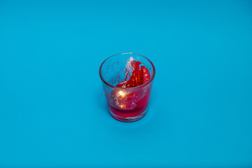 Red candle against a blue background