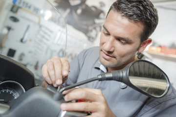 Naklejka premium Repairing a customer's scooter
