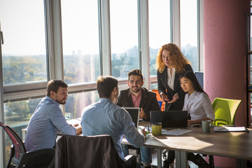Business people listening to one of their colleague bad or good news for their company, enterprise...