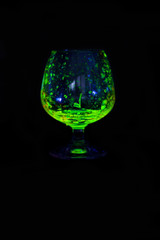Glass of whiskey glow in the dark.