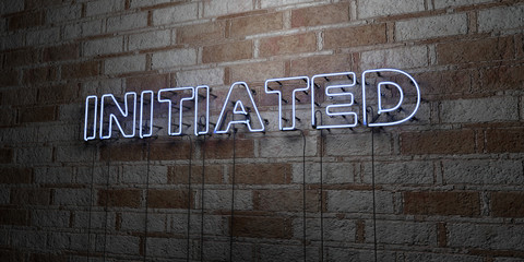 INITIATED - Glowing Neon Sign on stonework wall - 3D rendered royalty free stock illustration.  Can be used for online banner ads and direct mailers..