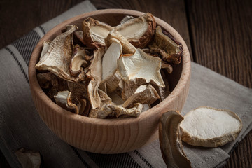 Dried mushrooms in wooden bowl.