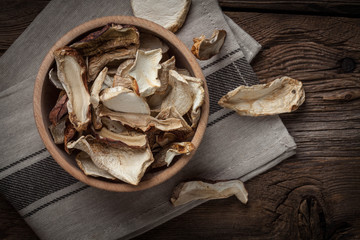 Dried mushrooms in wooden bowl.