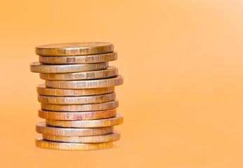 Stack of 10 rubles coins against golden background