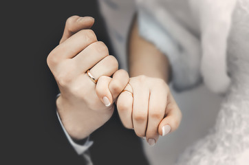 The hands of young people in the castle with rings