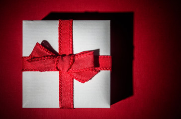 Little white gift isolated on red background