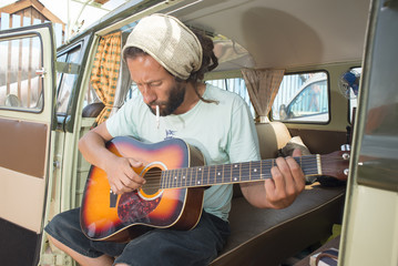 Hippie with Guitar in Old Van