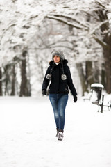 Middle-age woman walking in city park 