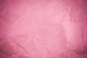 Pink crumpled recycle paper background.